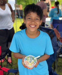 Young Entrepreneur holding a candle she made at a local market.